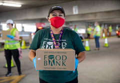 A volunteer handing out food